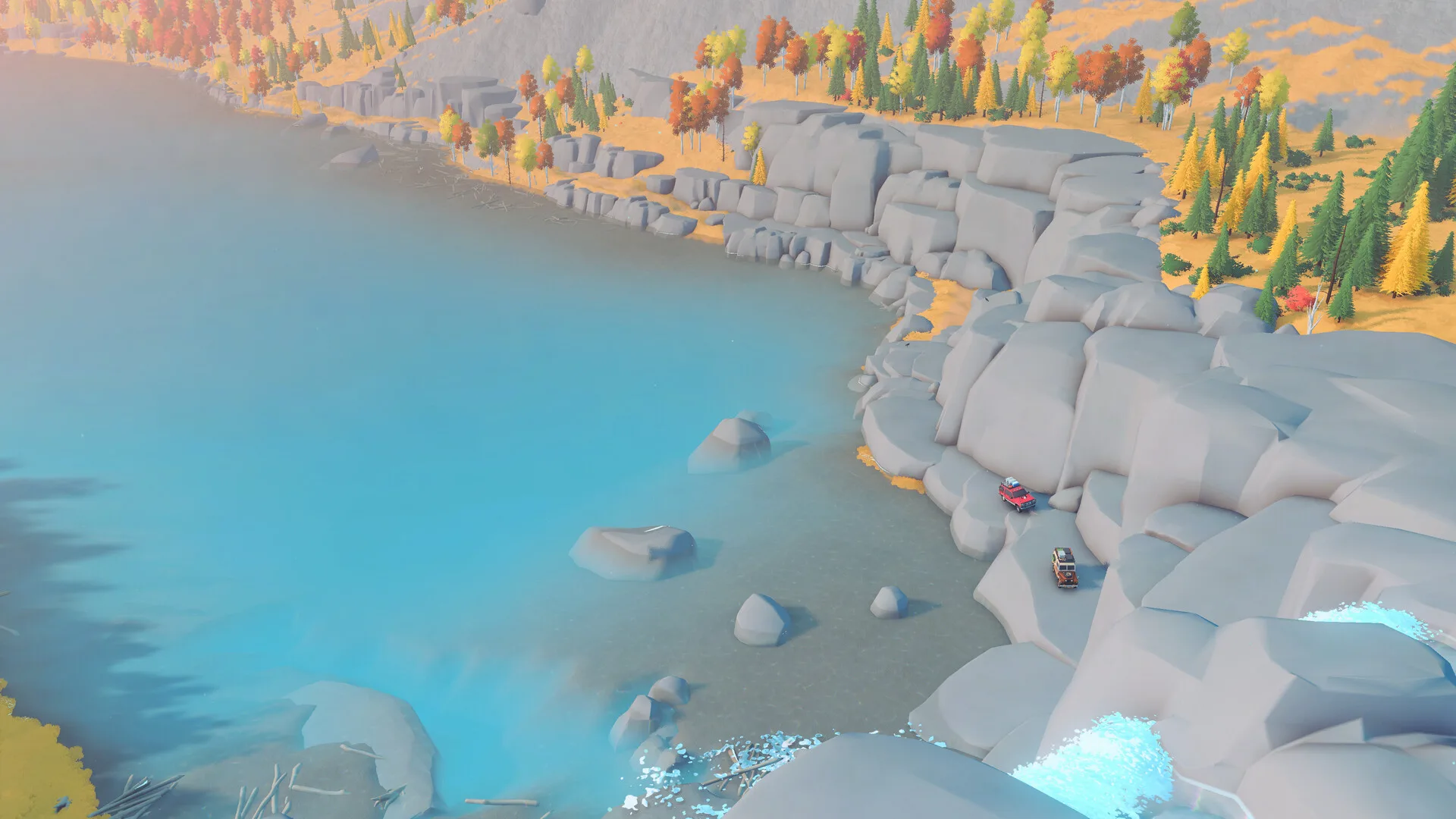 Over the Hill official screenshot of two 4x4 vehicles on a rocky lakeshore